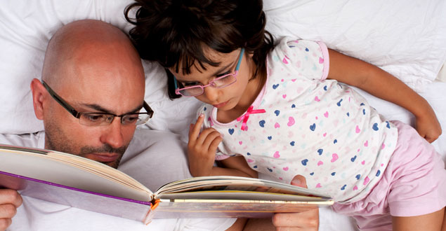 Father reading to his daughter
