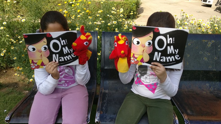 Cheryl and Arshiya reading the book with Dabi