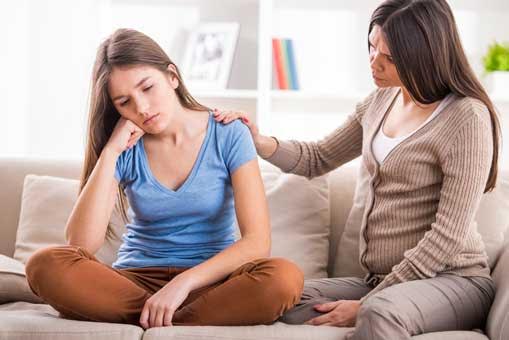 A mother trying to comfort her not-so-happy daughter